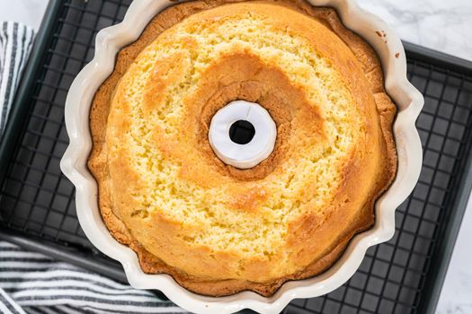 Freshly baked lemon bundt cake in a bundt cake pan.