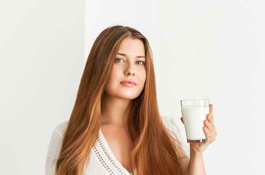 Diet, health and wellness concept, woman holding glass of milk or protein shake cocktail