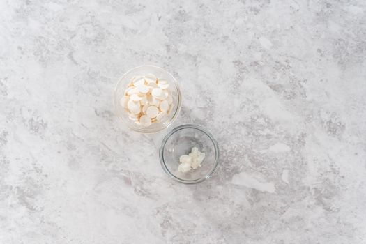 Flat lay. Melting white chocolate chips in a candy melting pot to drizzle over eggnog scones.