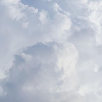 Cloudy sky background with sunlight shining through white clouds. Natural backdrop