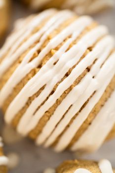 Freshly baked chocolate cookies with eggnog scones with a white chocolate drizzle on top.