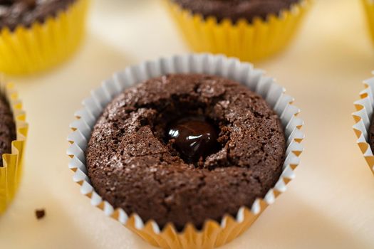 Filling s'mores cupcakes with chocolate ganache.