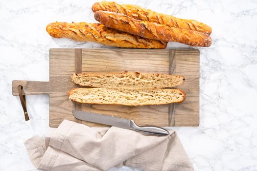 Flat lay. Freshly baked small French baguette bread.