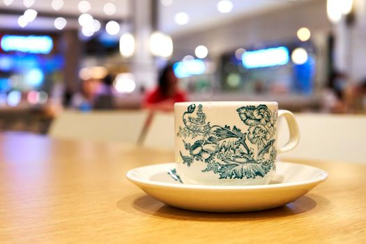 Cup of lemon tea with China style ornaments printed on it.