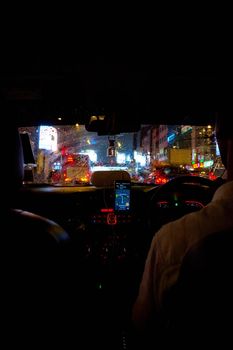 interior of a car driving night rainy city. blurred city lights. Kuala Lumpur, Malaysia - 04.01.2020