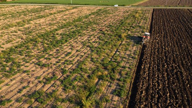 Aerial view with drone of tractor plowing the land in the countryside.