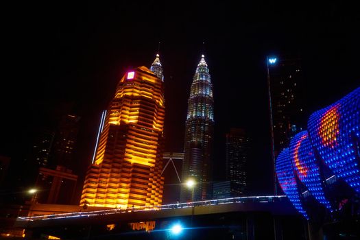 NIght view landscape of KL Petronas twin towers. Modern asian city with beautiful street lights. Kuala Lumpur, Malaysia - 04.01.2020