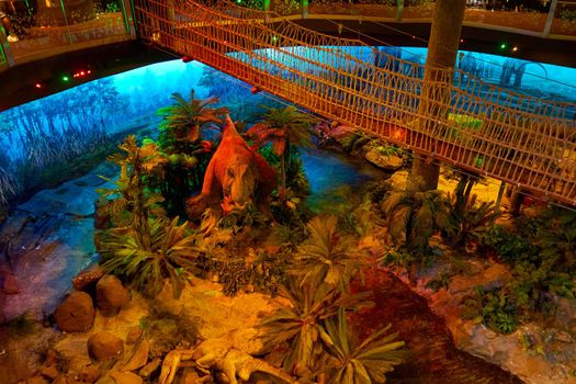 Interior museum of jurassic park with robotic dinosaurs. Kuala Lumpur, Malaysia - 04.01.2020