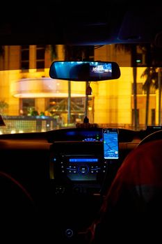 interior of a car driving night rainy city. blurred city lights. Kuala Lumpur, Malaysia - 04.01.2020