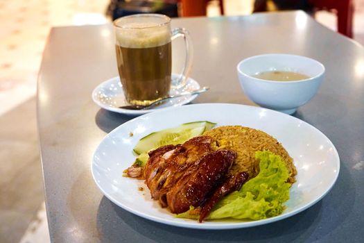 Business lunch in an Asian cafe. Rice with chicken drink and soup.