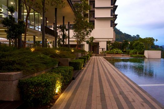 Exterior of modern condominium complex with swimming pool.