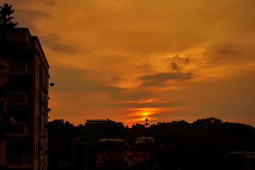 Burning orange sunset over the village. a