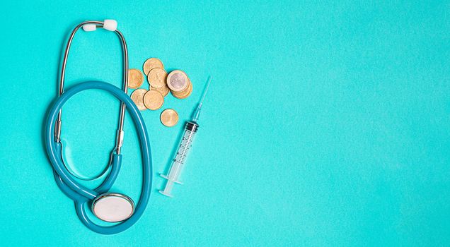 Concept of scientific research in medicine. Biotechnology banner with medical syringe stethoscope and money. Copyspace for text. flatlay.