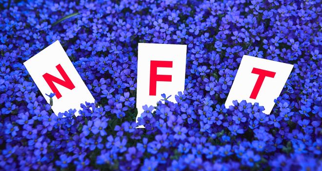 NFT Non-fungible token. Lettering in flowers. A technology for selling unique collectibles, game characters, blockchain assets, and digital artworks. The future of the art market. Cryptocurrencies and e-commerce.