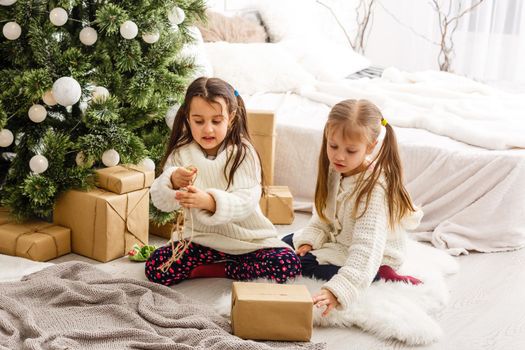 christmas, x-mas, winter, happiness concept - two adorable girls playing.