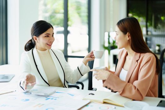 female marketing and sales employee talking and taking a coffee break