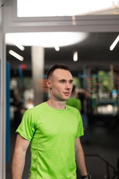 A male trainee taking a break from the workout session at the crossfit box