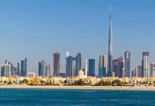 Dubai, UAE - 02.27.2021 Dubai public beach with city skyline on background.