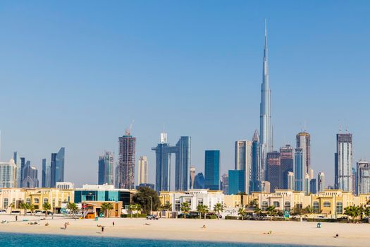 Dubai, UAE - 02.27.2021 Dubai public beach with city skyline on background.