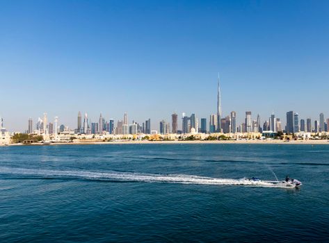 Dubai, UAE - 02.27.2021 Dubai public beach with city skyline on background.