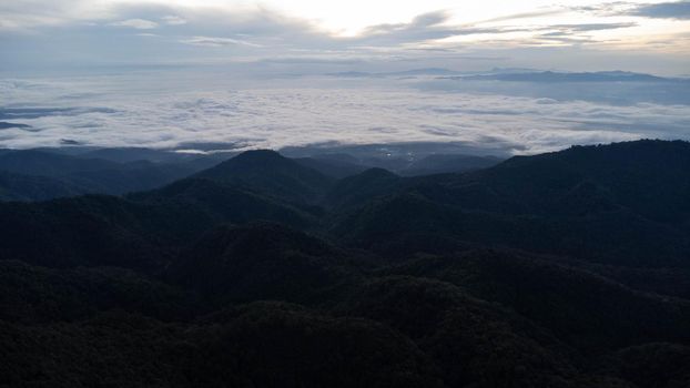 Aerial view of sea of fog on tropical mountains in the early morning.