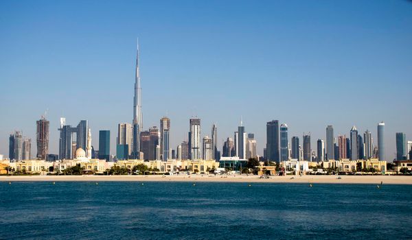 Dubai, UAE - 02.27.2021 Dubai public beach with city skyline on background.