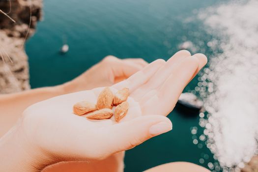 Unrecognizable caucasian woman eating young milky almond nuts. Healthy vegan food