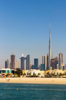 Dubai, UAE - 02.27.2021 Dubai public beach with city skyline on background.