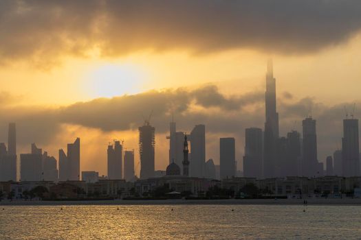 Dubai, UAE - 03.06.2021 Dubai public beach with city skyline on background.Sunrise hour