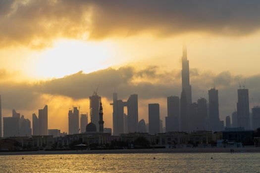 Dubai, UAE - 03.06.2021 Dubai public beach with city skyline on background.Sunrise hour