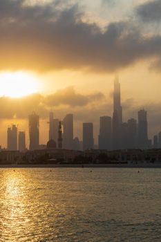 Dubai, UAE - 03.06.2021 Dubai public beach with city skyline on background.Sunrise hour