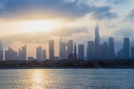 Dubai, UAE - 03.06.2021 Dubai public beach with city skyline on background.Sunrise hour