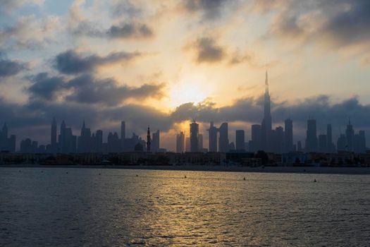 Dubai, UAE - 03.06.2021 Dubai public beach with city skyline on background.Sunrise hour