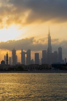 Dubai, UAE - 03.06.2021 Dubai public beach with city skyline on background.Sunrise hour