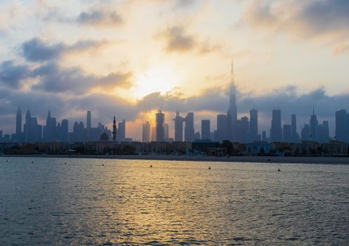 Dubai, UAE - 03.06.2021 Dubai public beach with city skyline on background.Sunrise hour