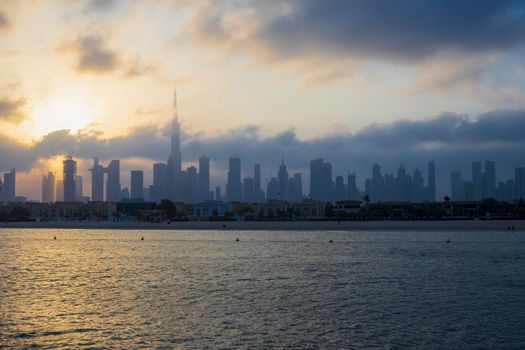 Dubai, UAE - 03.06.2021 Dubai public beach with city skyline on background.Sunrise hour