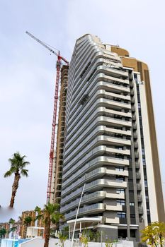 Benidorm, Alicante, Spain- September 11, 2022: Modern architecture building called Sunset Cliffs under construction in the Poniente Beach Area in Benidorm