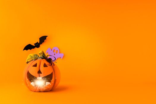 Happy halloween holiday concept. Jack o lantern, handmade paper decorations, spiders, ghosts, bats on orange background. Halloween festival party, greeting card mockup with copy space.