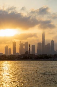 Dubai, UAE - 03.06.2021 Dubai public beach with city skyline on background.Sunrise hour