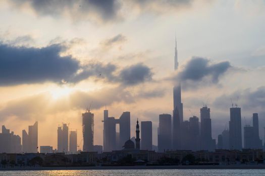 Dubai, UAE - 03.06.2021 Dubai public beach with city skyline on background.Sunrise hour