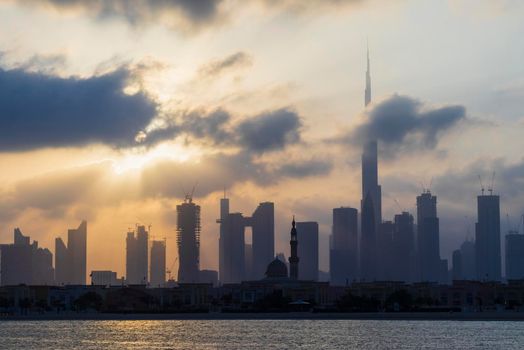 Dubai, UAE - 03.06.2021 Dubai public beach with city skyline on background.Sunrise hour