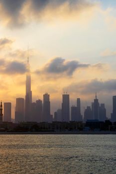 Dubai, UAE - 03.06.2021 Dubai public beach with city skyline on background.Sunrise hour