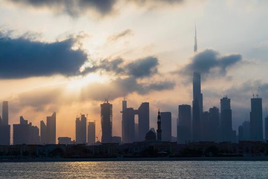 Dubai, UAE - 03.06.2021 Dubai public beach with city skyline on background.Sunrise hour