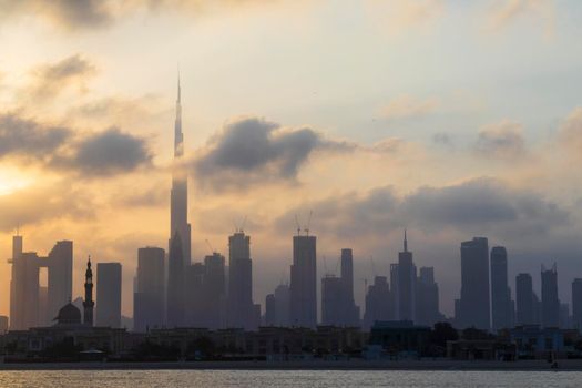 Dubai, UAE - 03.06.2021 Dubai public beach with city skyline on background.Sunrise hour