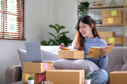 Starting small businesses SME owners female entrepreneurs Write the address on receipt box and check online orders to prepare to pack the boxes, sell to customers, sme business ideas online..