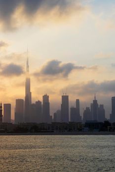 Dubai, UAE - 03.06.2021 Dubai public beach with city skyline on background.Sunrise hour