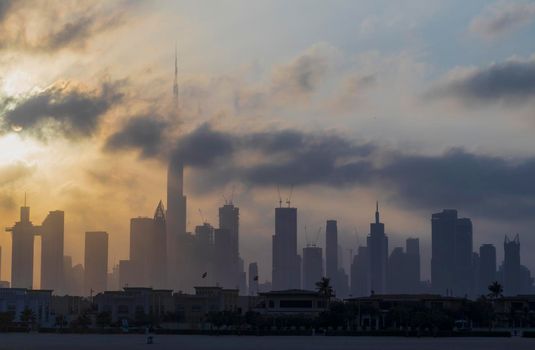 Dubai, UAE - 03.06.2021 Dubai public beach with city skyline on background.Sunrise hour