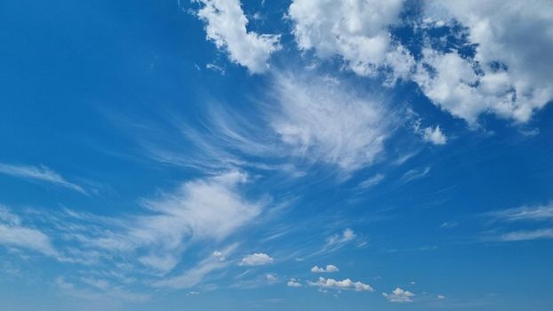 Blue sky with clouds. Beautiful natural background. Ready to wallpaper.