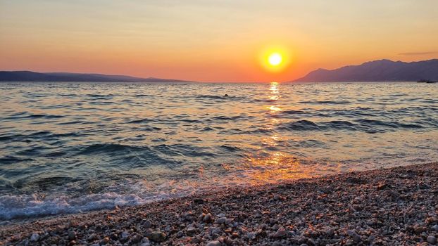 Beautiful red sunset over the Adriatic sea. Makarska Riviera-Biokovo, Dalmatia, Croatia, Europe.