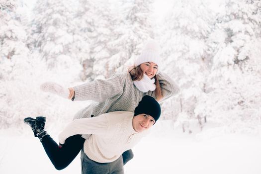 A couple in love in winter in the forest lifestyle . An article about love. An article about Valentine 's Day . A happy couple.